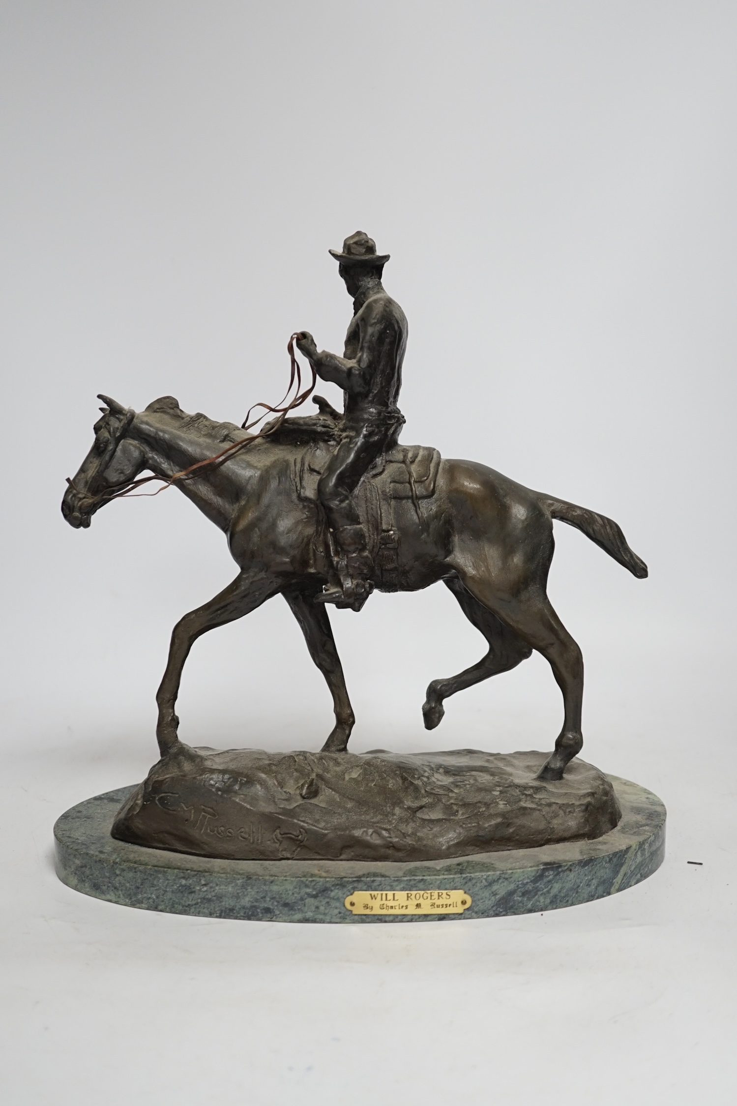 After Charles Marian Russell, a bronze group of Will Rogers, 29cm high